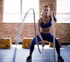 Woman using ropes in a gym workout